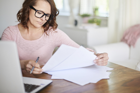 Woman Completing Invoice Factoring Paperwork - 12-11